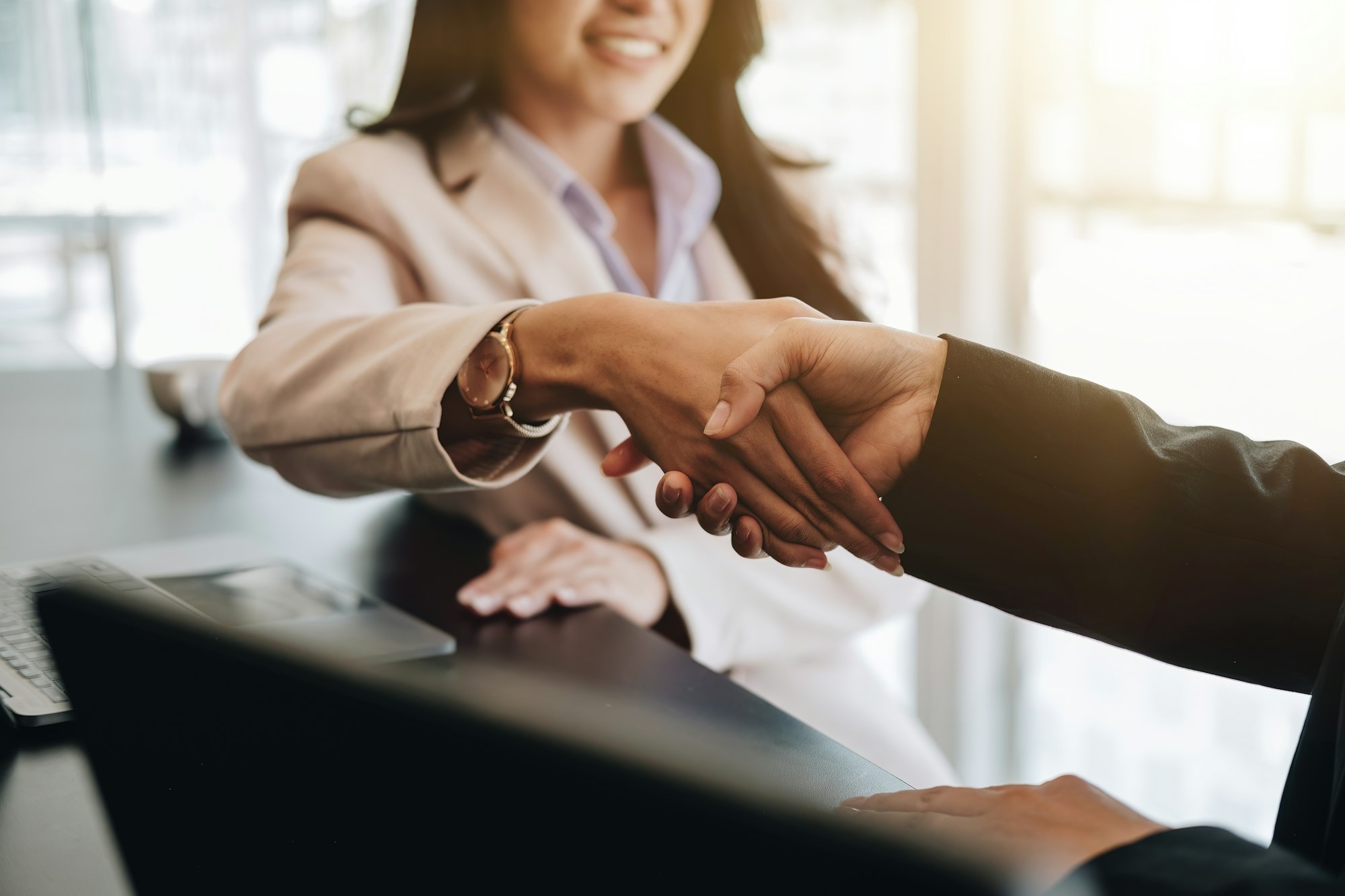 Close up of asian business people shaking hand, finishing up meeting, business etiquette